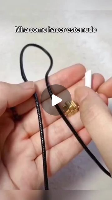 a person is holding something in their hand with a cord attached to the end of it