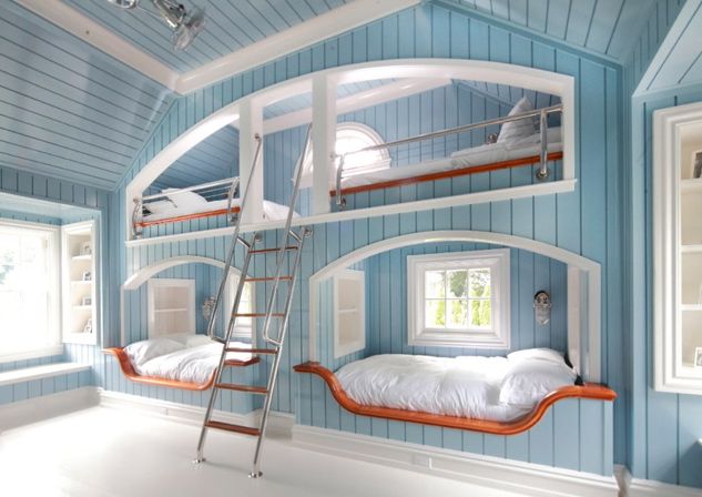 a room with bunk beds and ladders in the ceiling, blue walls and white floors