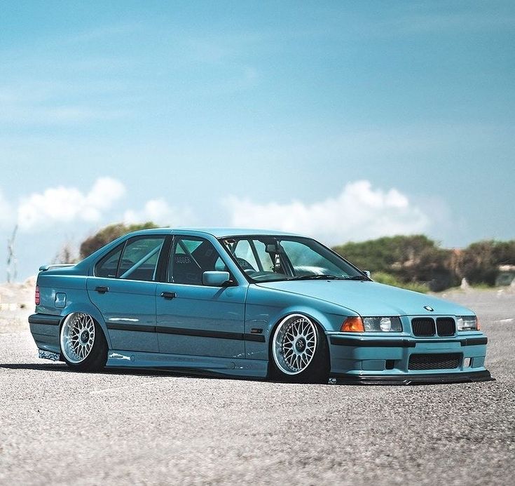 a blue car parked on the side of a road