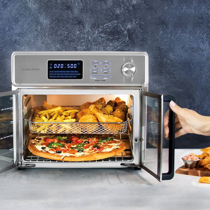 a person reaching into an open microwave with food in the trays on it,