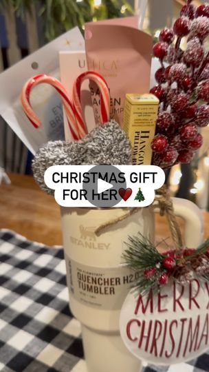 a cup filled with candy canes and other holiday items on top of a table