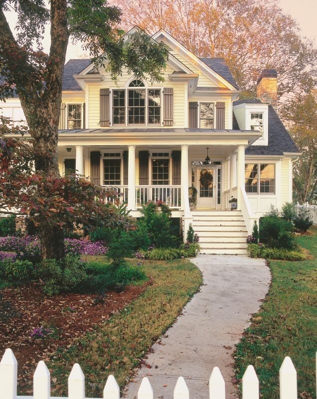 a house with a white picket fence in front of it