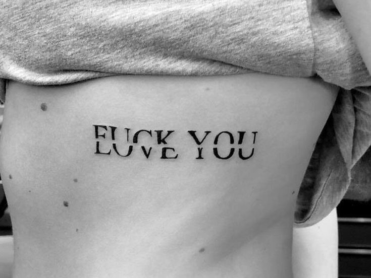 a woman's stomach with the words i love you tattooed on her lower back