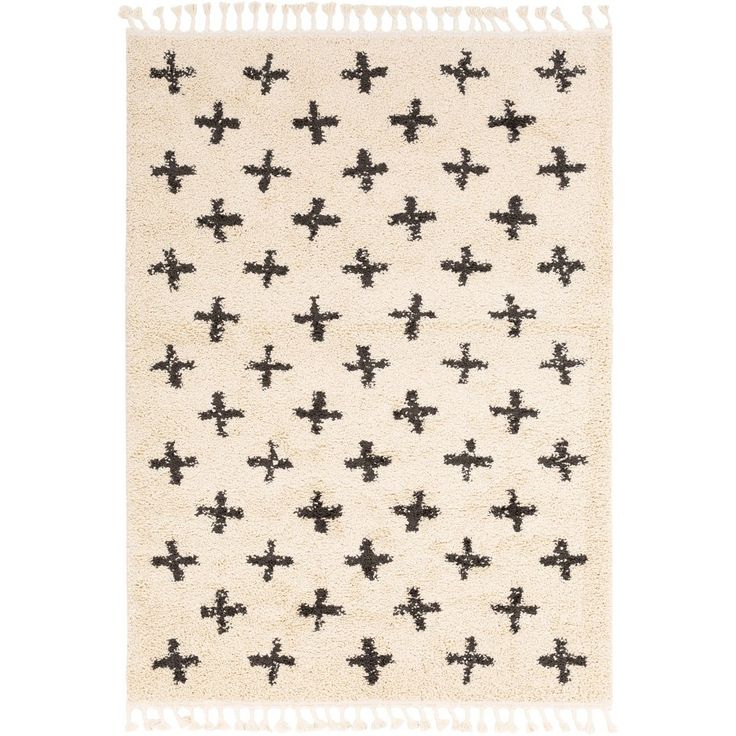 a black and white rug with crosses on the front, in various sizes and colors