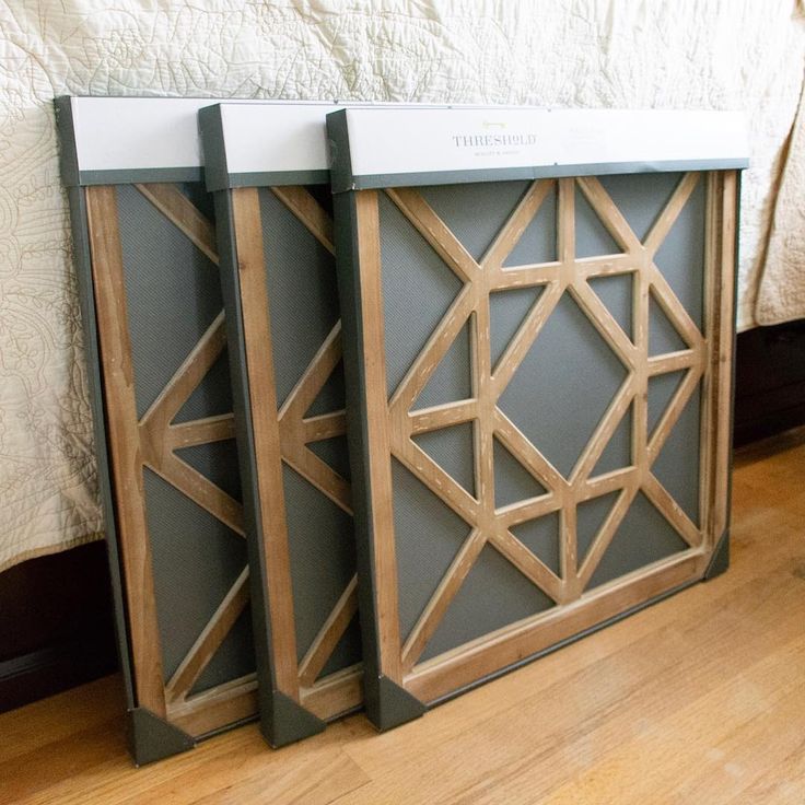 two side tables sitting next to each other on a wooden floor