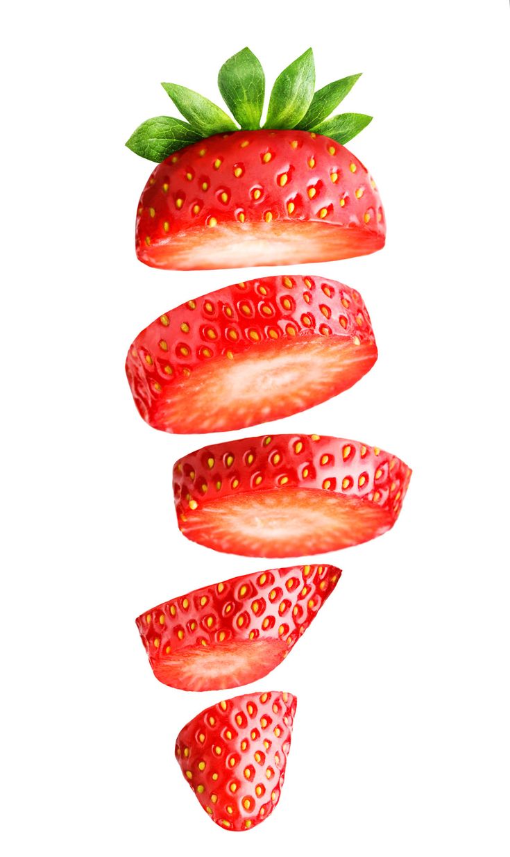 three strawberries with green leaves on top and one strawberry sliced in half, hanging upside down