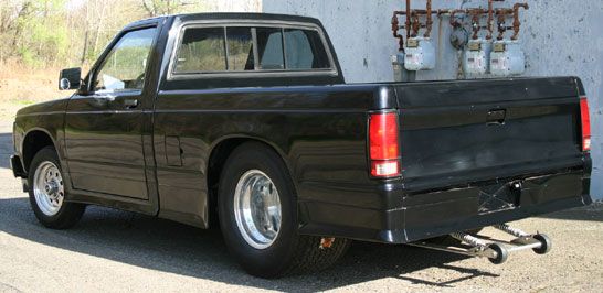 a black pick up truck parked in front of a building