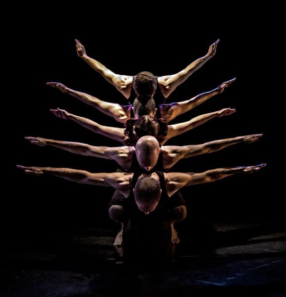 the dancers are standing in a circle together