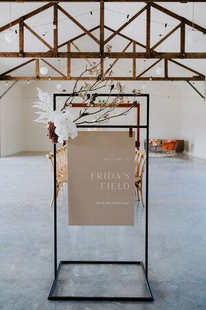 a sign that says friday's feed in front of a table with chairs and flowers