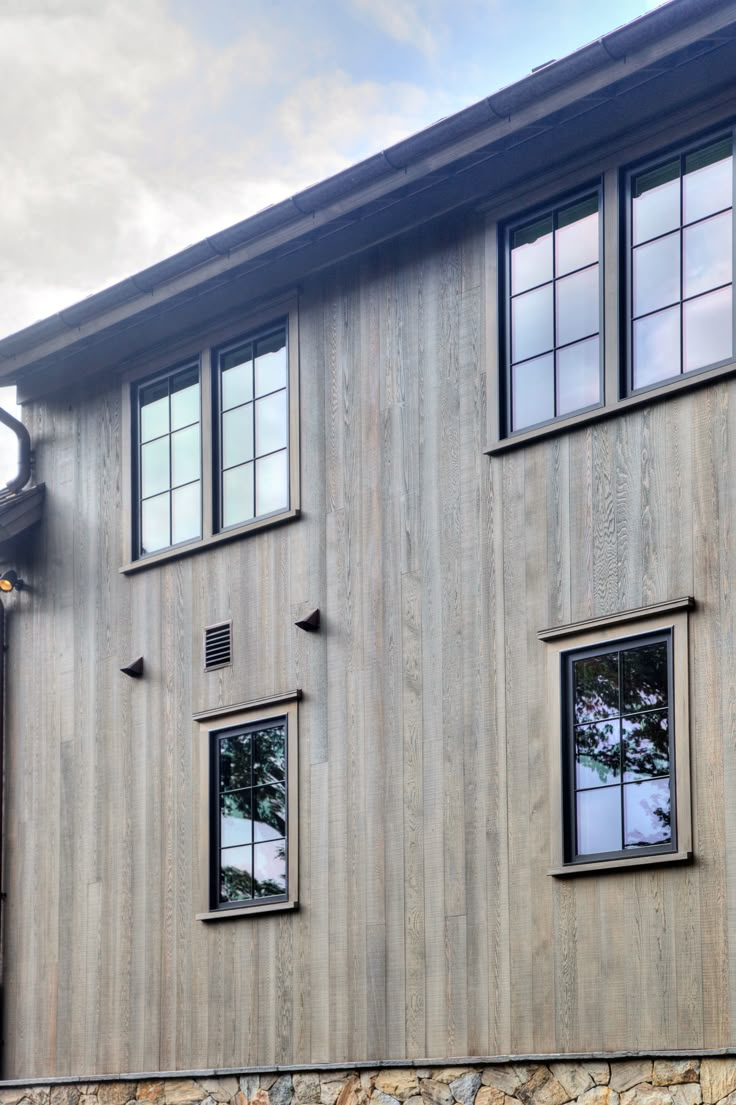 two windows on the side of a building