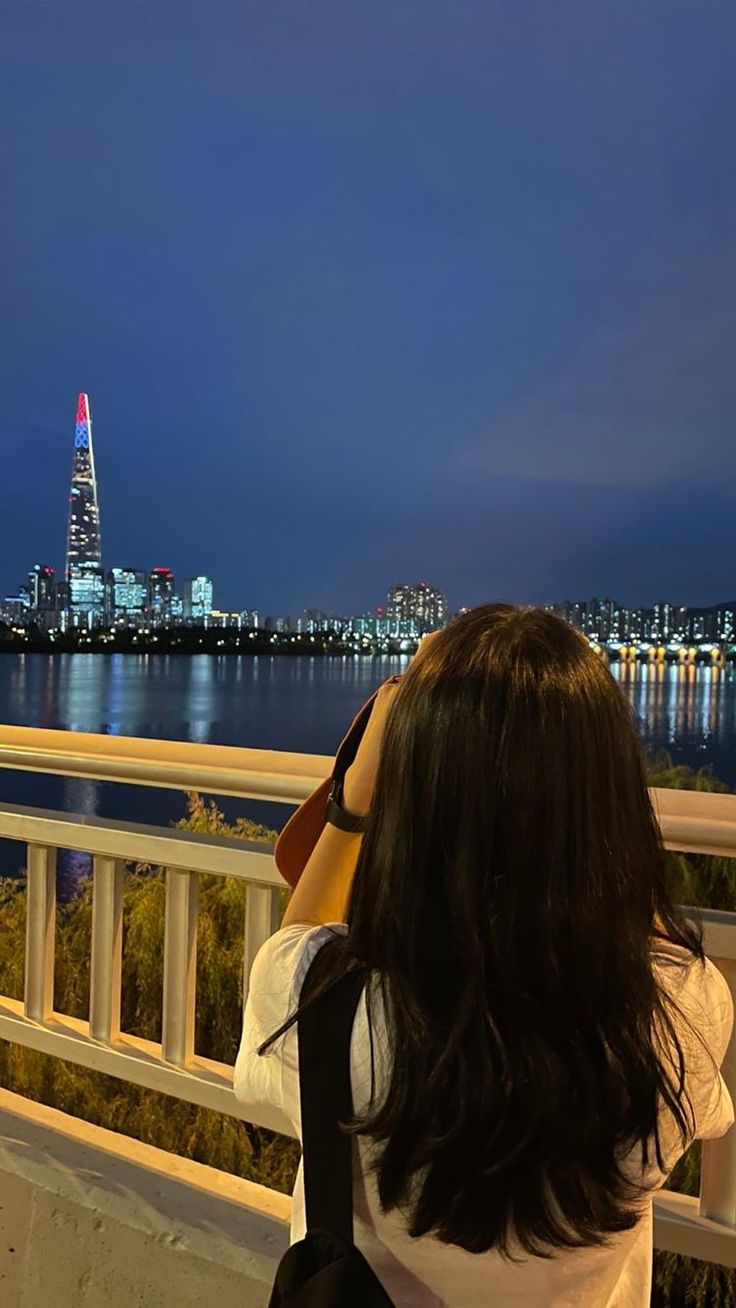 a woman looking at the city skyline with her binoculars