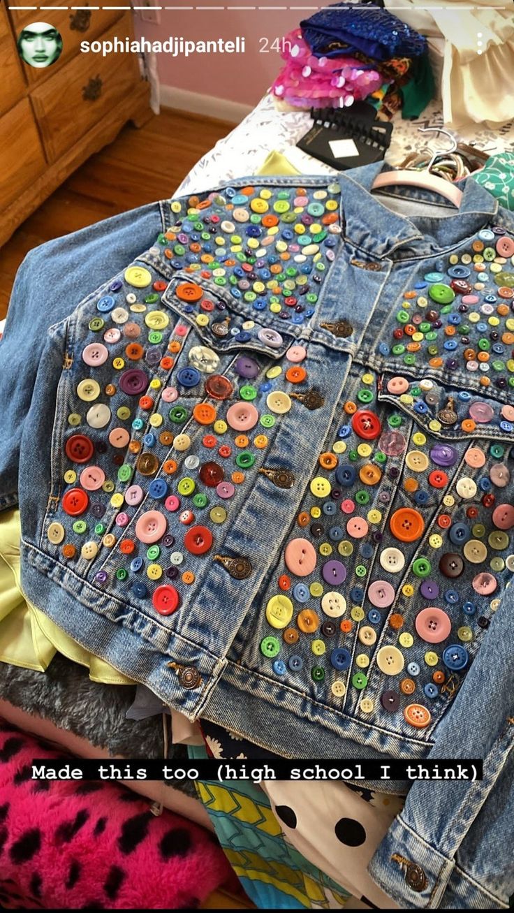 a denim jacket with buttons on it and the words made this too high school i think