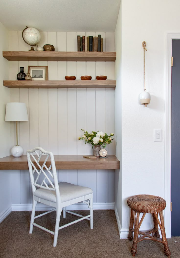 a white chair sitting next to a wooden shelf