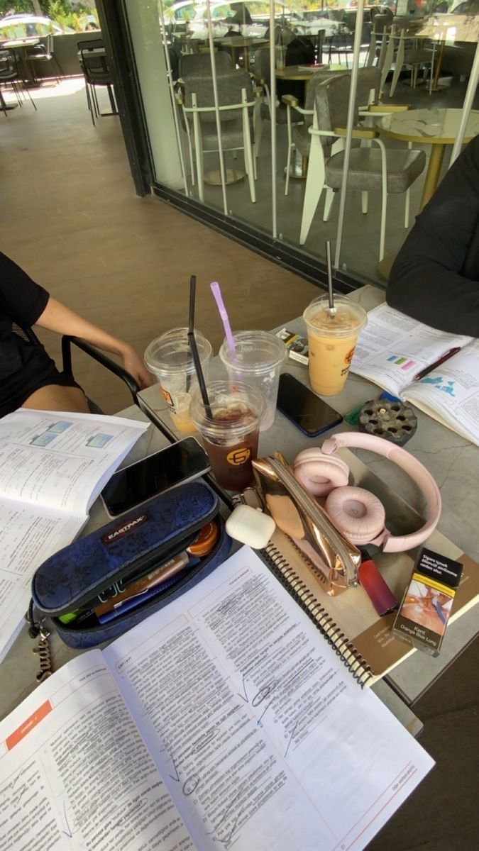 a table topped with papers and donuts on top of it