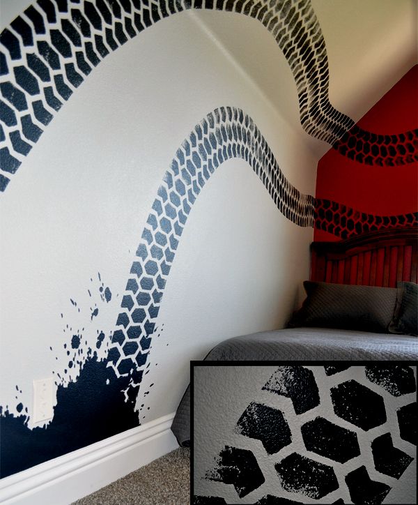 an image of a bedroom painted with black and white designs on the wall, next to a bed