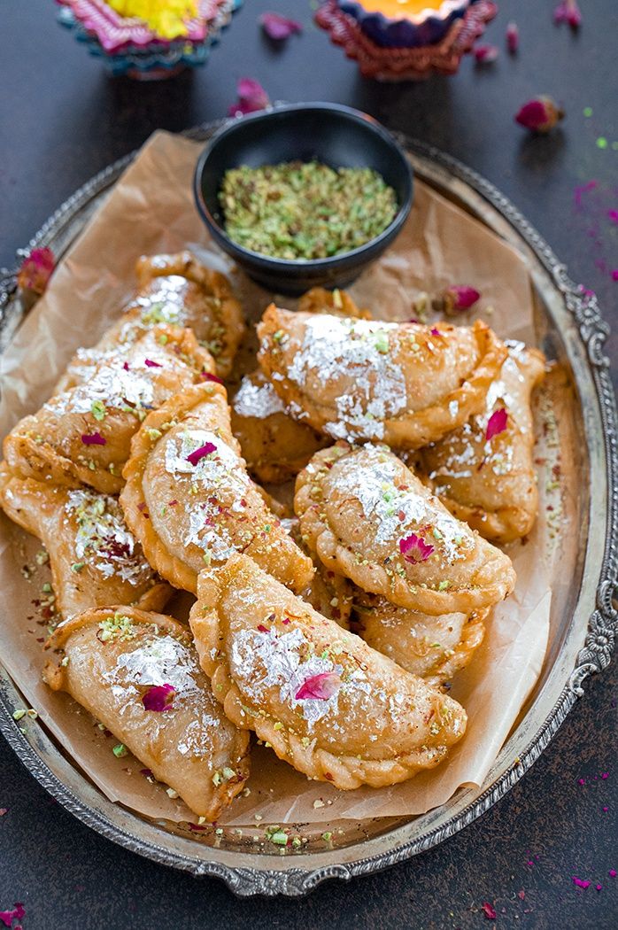 there are many pastries on the plate with powdered sugar and sprinkles