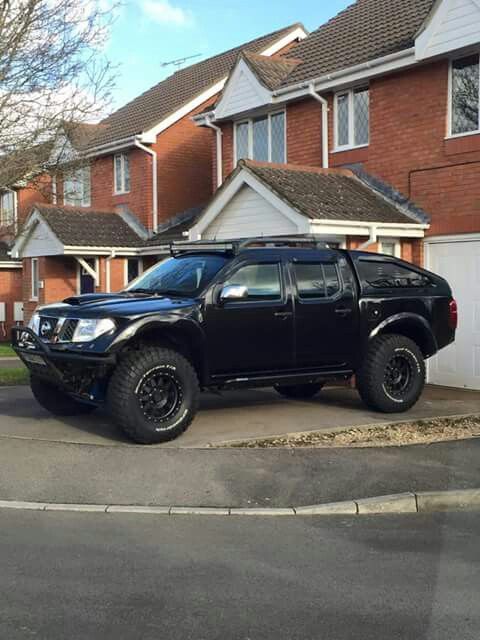 a black truck parked in front of a house