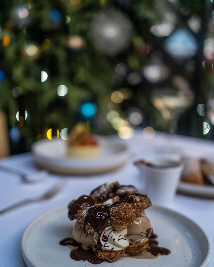 a white plate topped with dessert next to a christmas tree