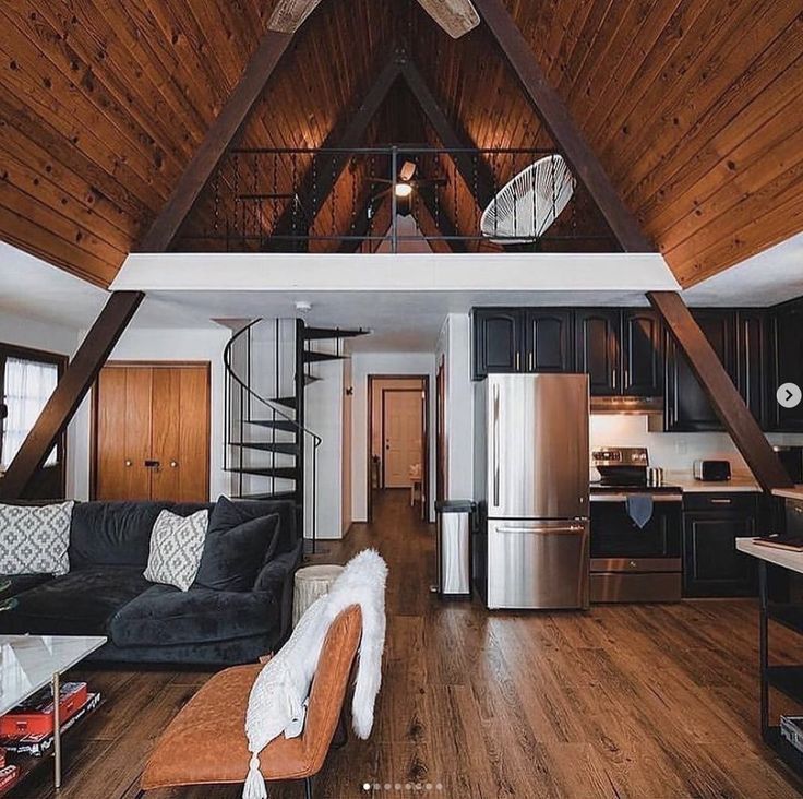 a living room filled with furniture and a spiral staircase