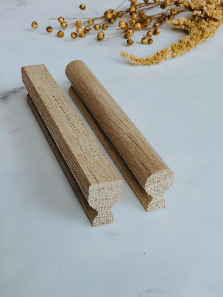 two wooden dowks sitting next to each other on a white surface with gold sprinkles