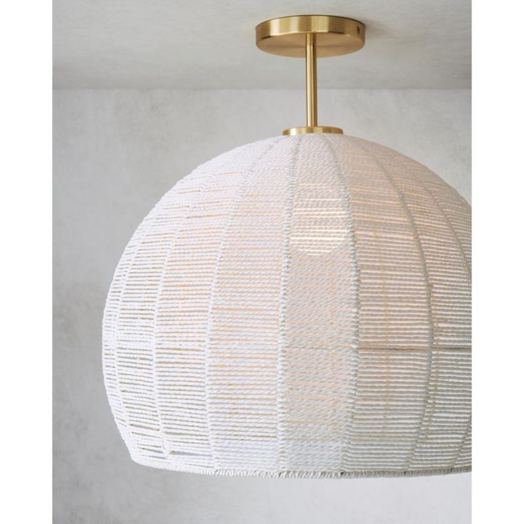 a white and gold light fixture hanging from the ceiling