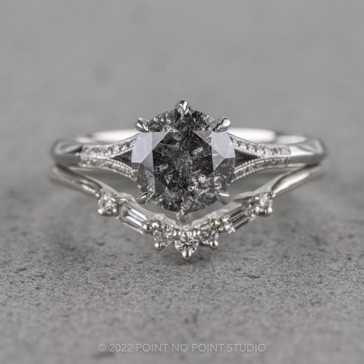 a white gold engagement ring set with an oval cut diamond and baguettes on the side