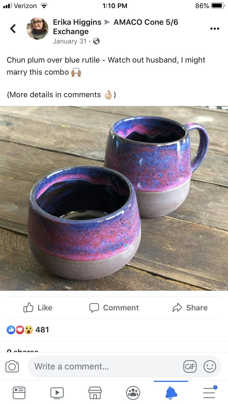 two coffee mugs sitting next to each other on top of a wooden table,