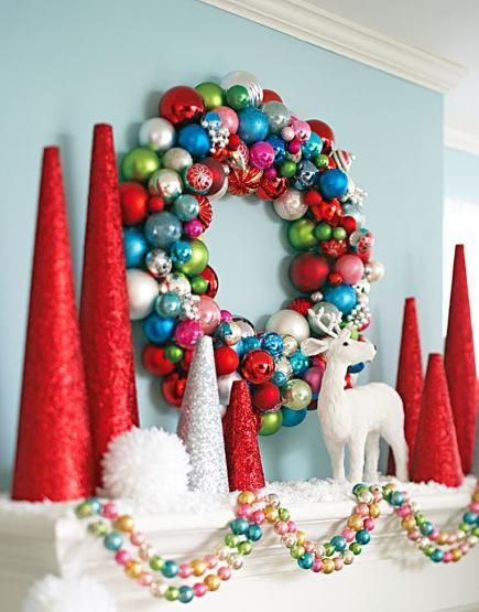 a christmas mantel decorated with red, white and green ornaments