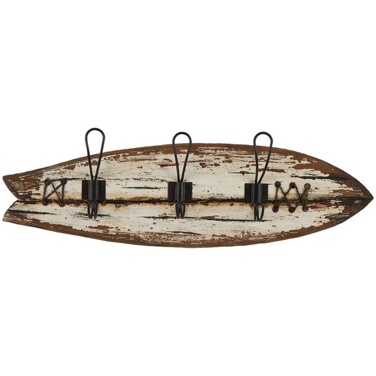 an old wooden surfboard with metal hooks