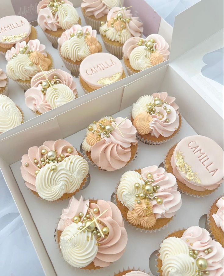 cupcakes with pink and white frosting in a box