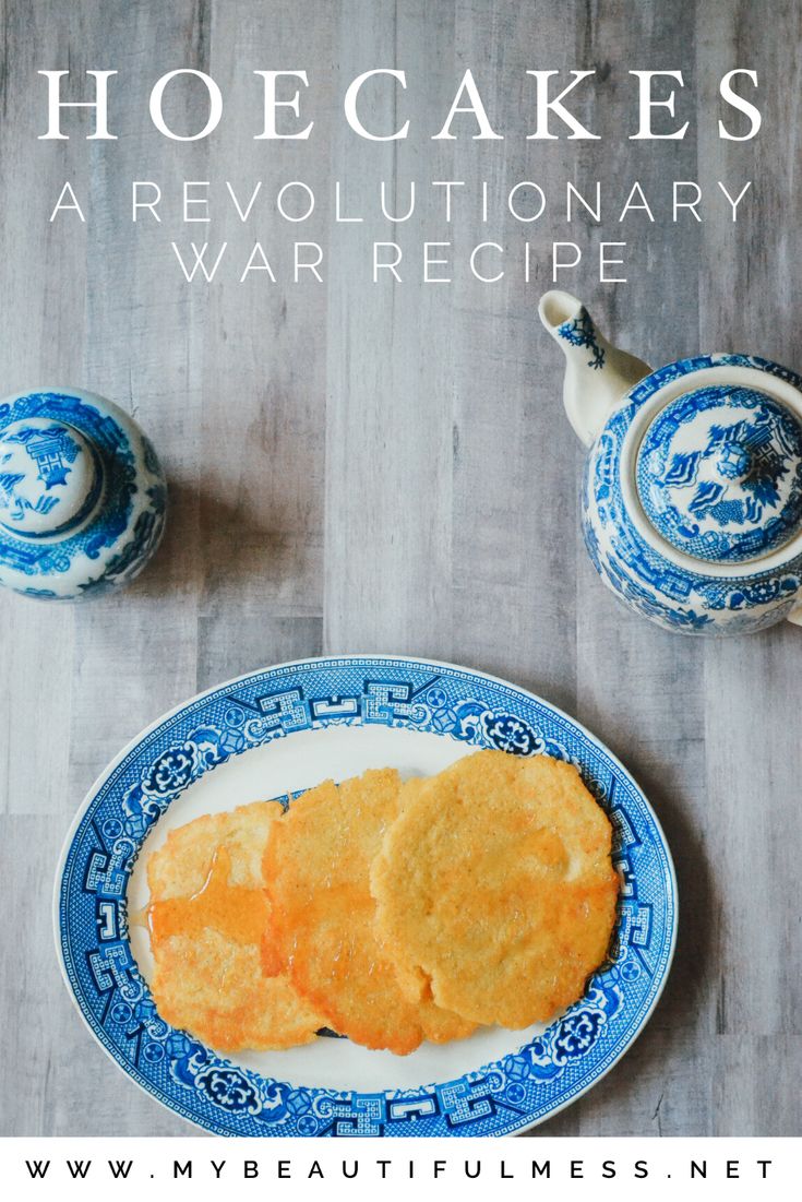 a blue and white plate topped with food next to two teapots on top of a wooden table