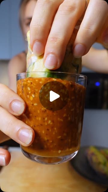 a person holding a glass filled with food