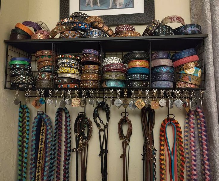 a shelf filled with lots of different colored ribbons and bracelets on top of it