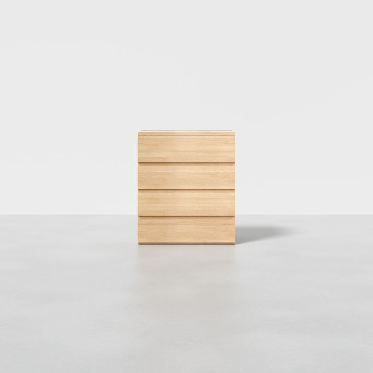 a wooden drawer sitting on top of a white floor