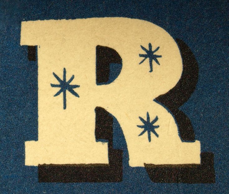 the letter r is made out of felt with blue and black stars on it's sides