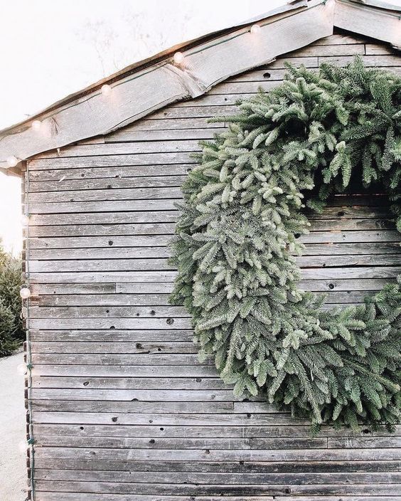 a wreath on the side of a wooden building