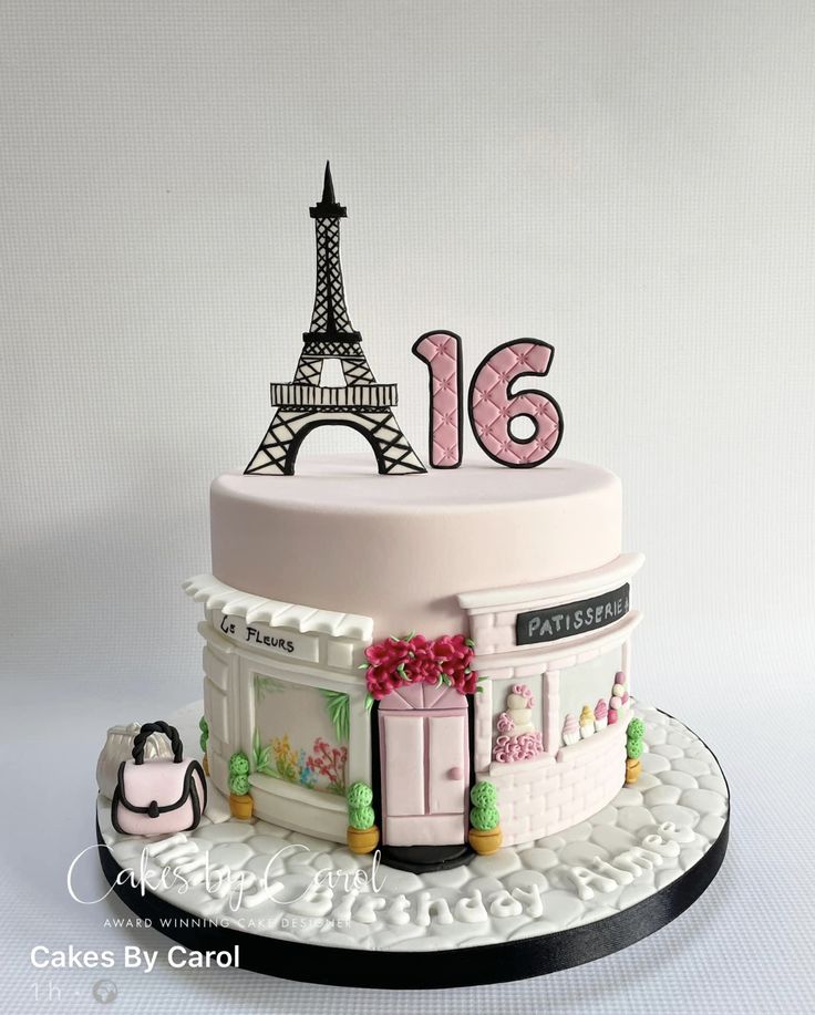 a birthday cake with the eiffel tower in paris on it's top