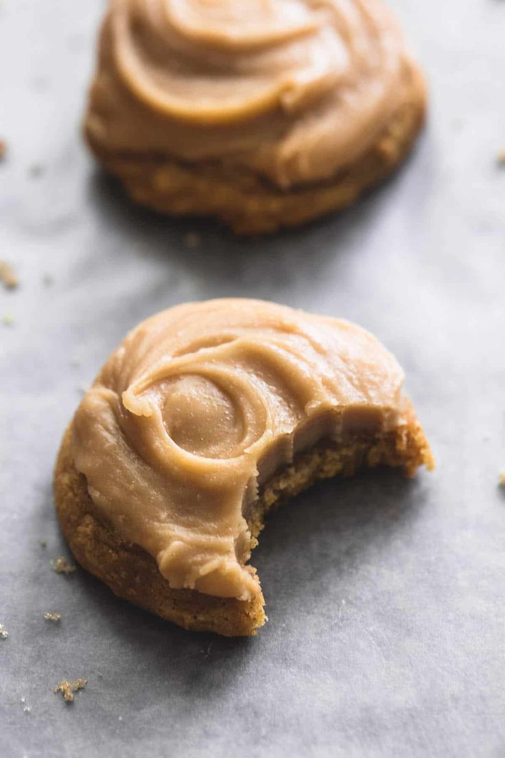 two cookies with peanut butter frosting cut in half