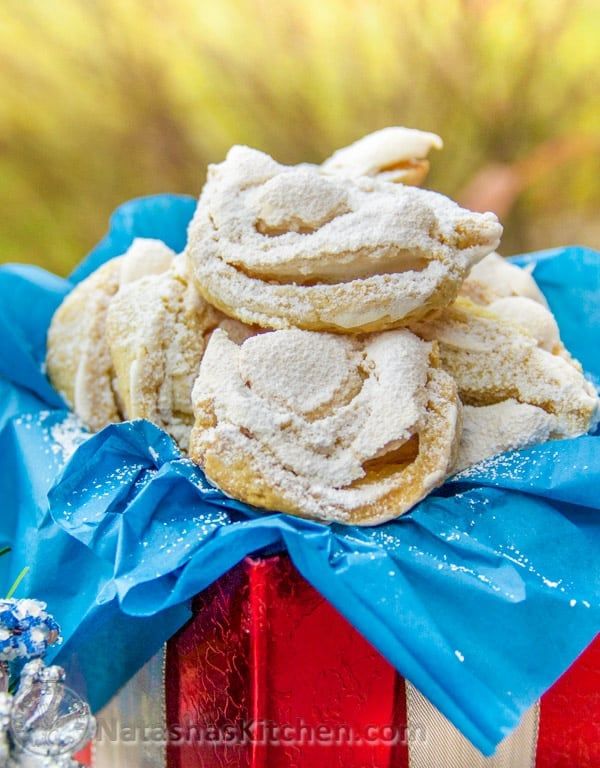 a pile of cookies sitting on top of a blue cloth covered red and white box