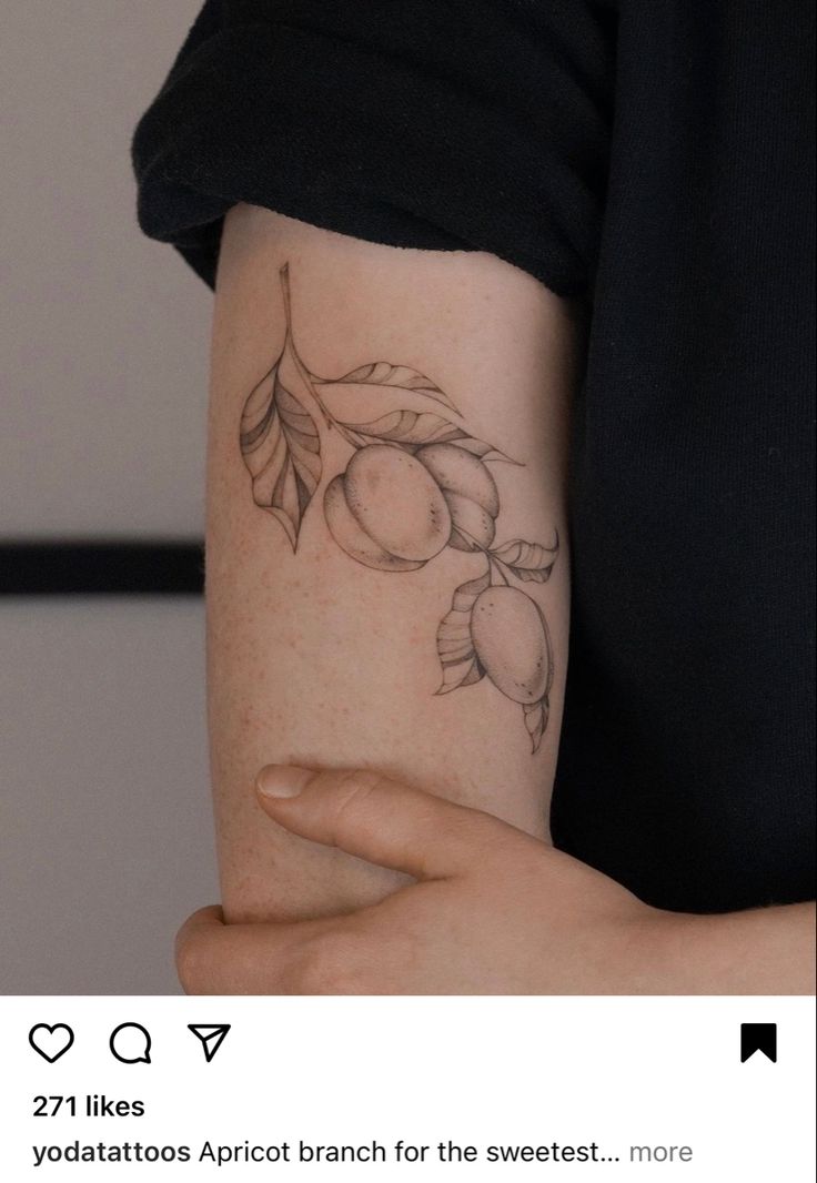 a woman's arm with a tattoo on it that has peaches and leaves