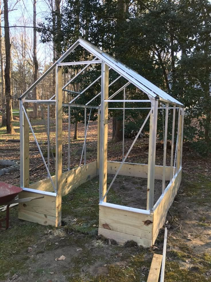 a small greenhouse built into the side of a yard