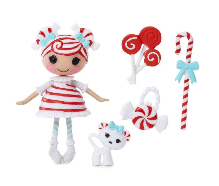 a doll and some candy canes on a white background