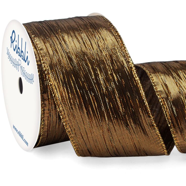 a spool of gold metallic foil on a roll of wired ribbon with a white background