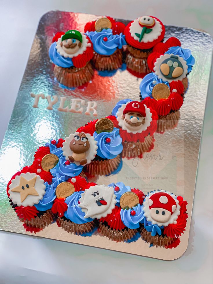 two cupcakes are decorated as mario and luigi's friends on top of each other