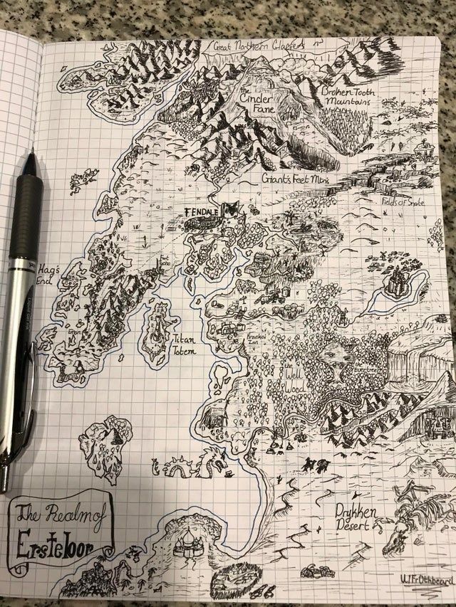 a notebook with a map drawn on it and a pen resting on the paper next to it