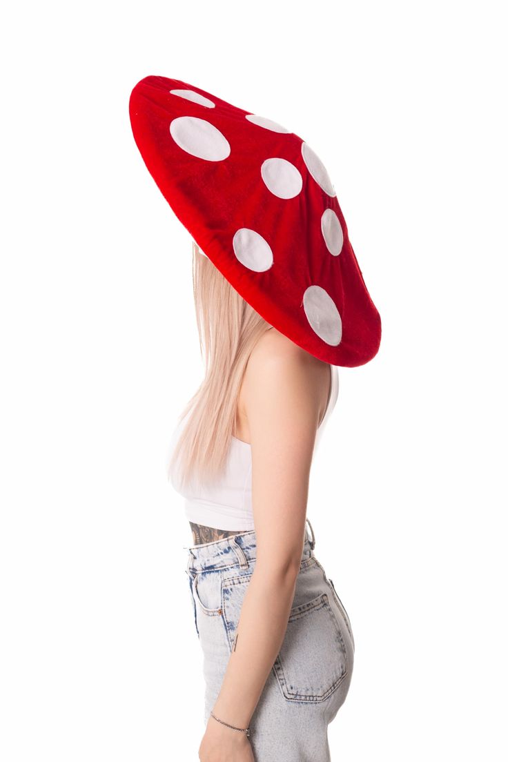 a woman wearing a red hat with white polka dots on the front and back side