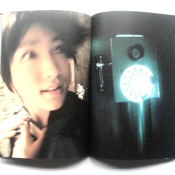 an open book with a photo of a woman next to a clock