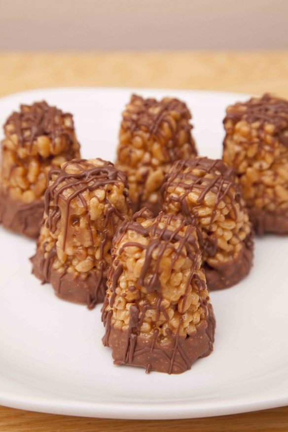 several pieces of chocolate and nuts on a white plate