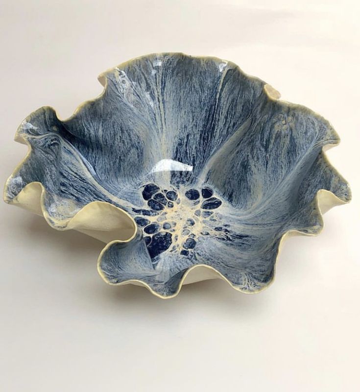 a blue and white bowl sitting on top of a table