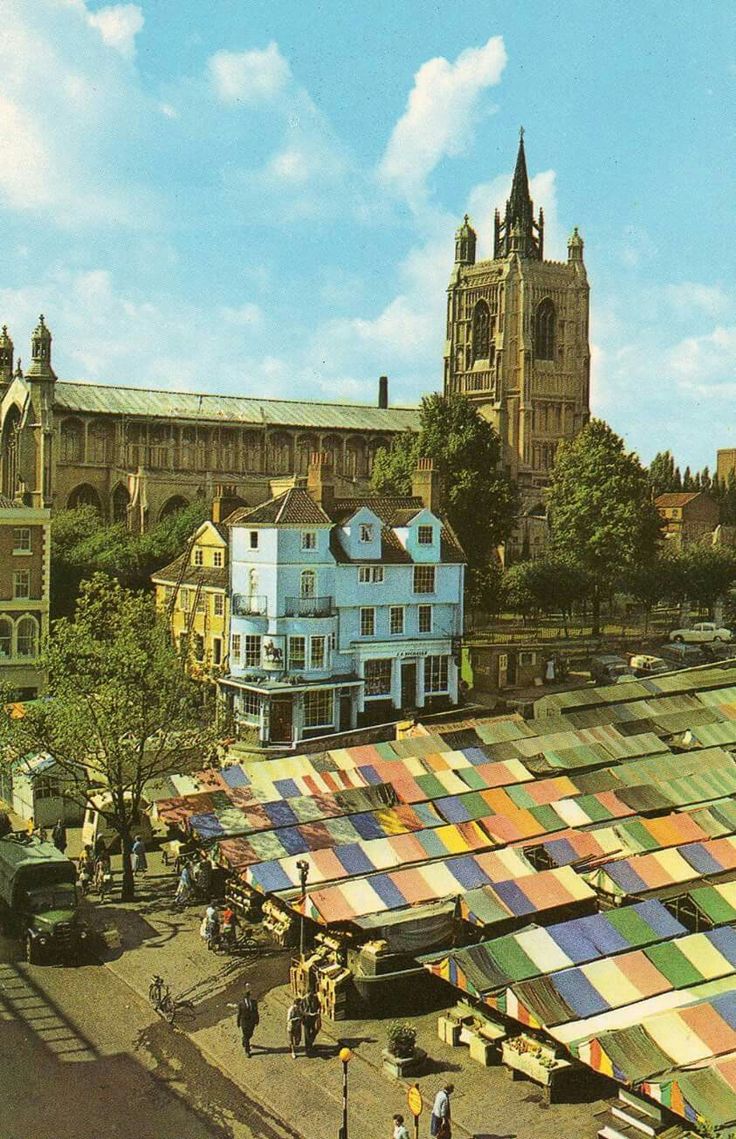 an aerial view of the city with people walking around and buildings in the foreground